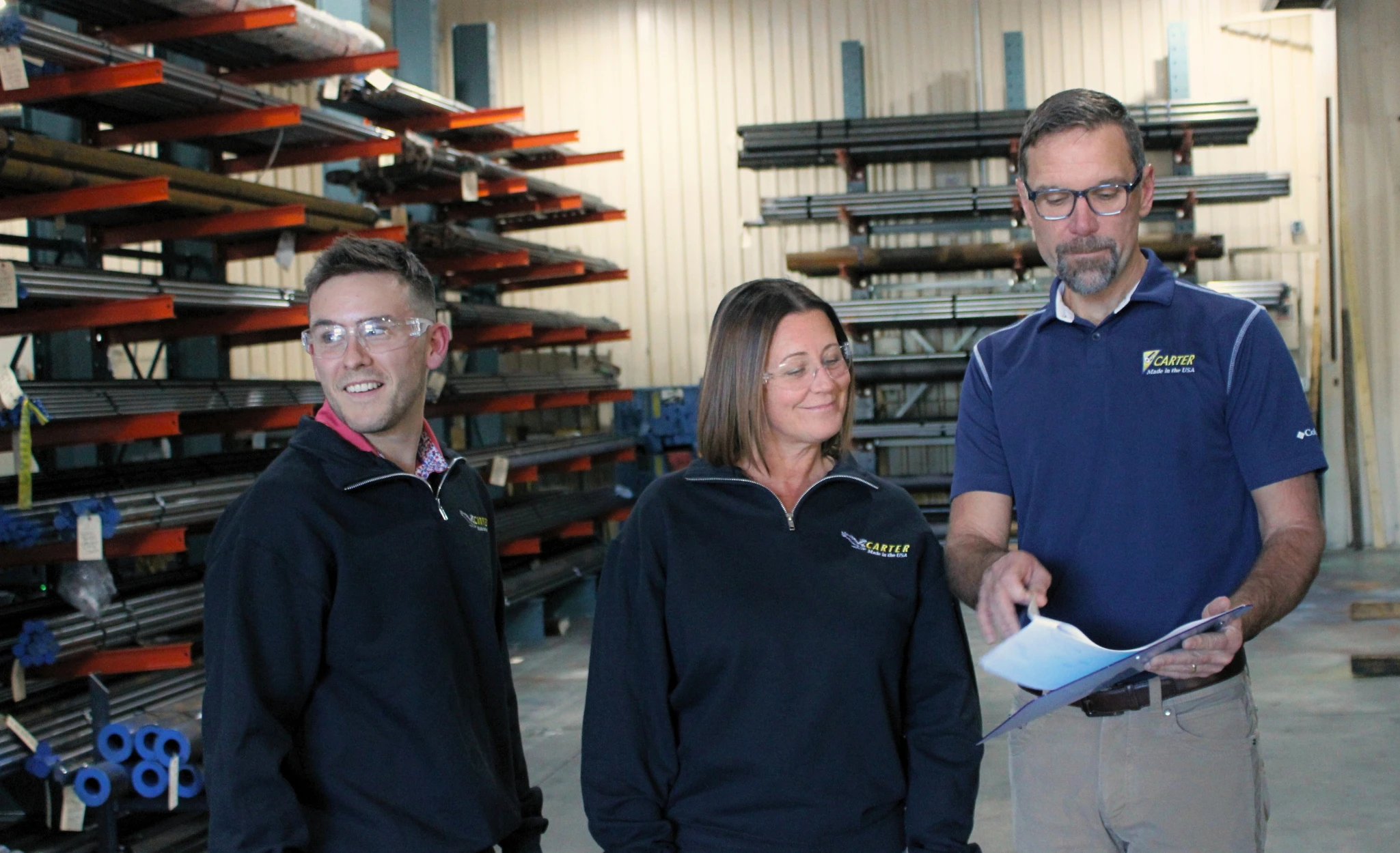 Carter Bearing Employees Going Over Paperwork in Factory
